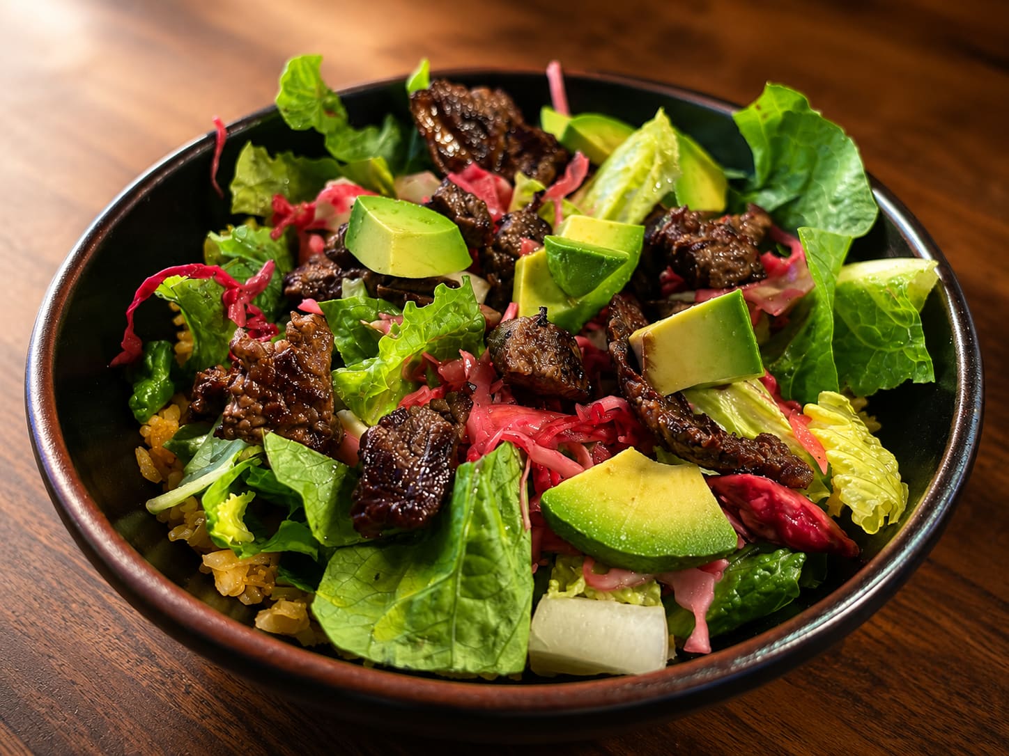 Abuela’s salad topped with carne asada, avocado and pickled red cabbage.